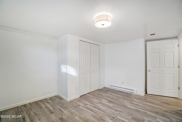 interior space featuring light hardwood / wood-style flooring and a baseboard heating unit