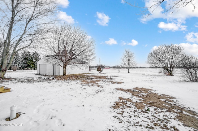 yard covered in snow with a garage