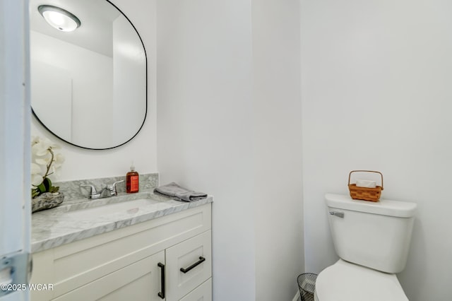 bathroom featuring toilet and vanity