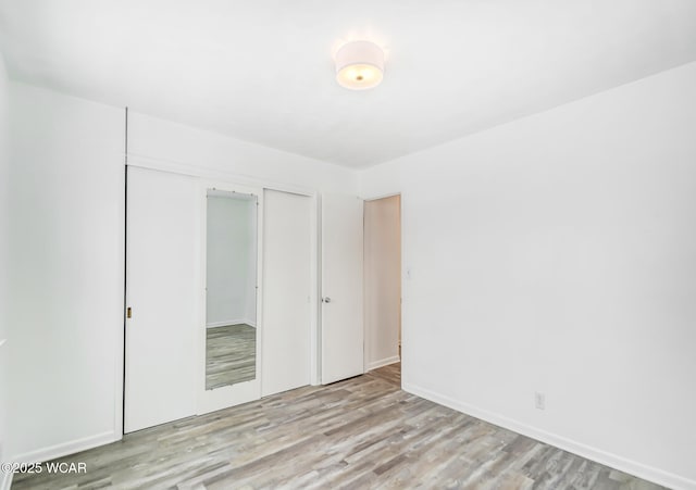 unfurnished bedroom featuring a closet and light hardwood / wood-style floors