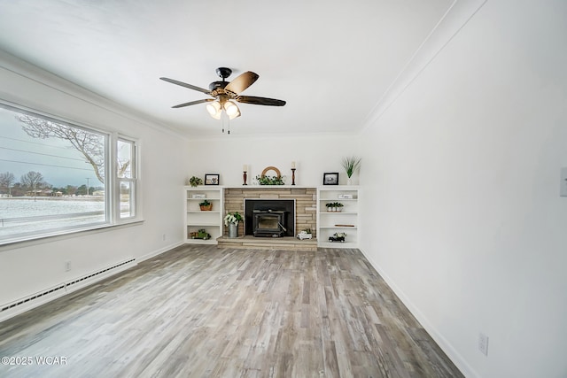 unfurnished living room with crown molding, hardwood / wood-style floors, ceiling fan, and a baseboard heating unit