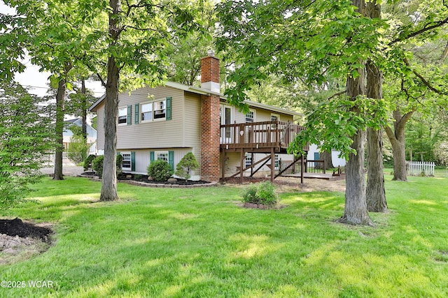 4940 Stewart Rd, Lima, OH 45801 - back of property with a wooden deck, a yard, and a chimney