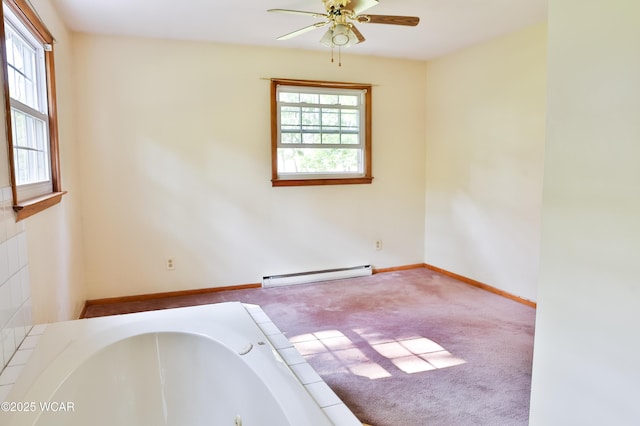 4940 Stewart Rd, Lima, OH 45801 - spare room featuring baseboard heating, a ceiling fan, carpet flooring, and baseboards