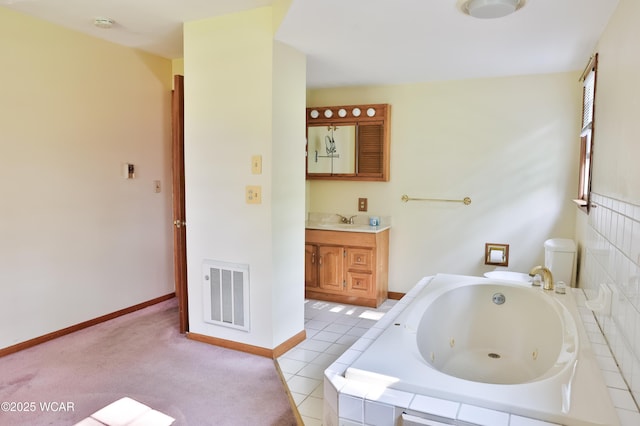4940 Stewart Rd, Lima, OH 45801 - full bathroom featuring vanity, a tub with jets, baseboards, and toilet