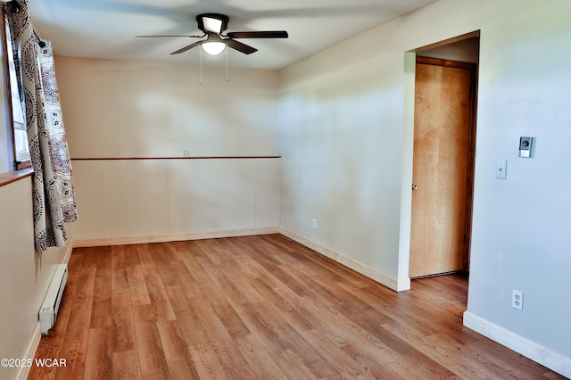 4940 Stewart Rd, Lima, OH 45801 - empty room featuring ceiling fan, a baseboard radiator, wood finished floors, and baseboards