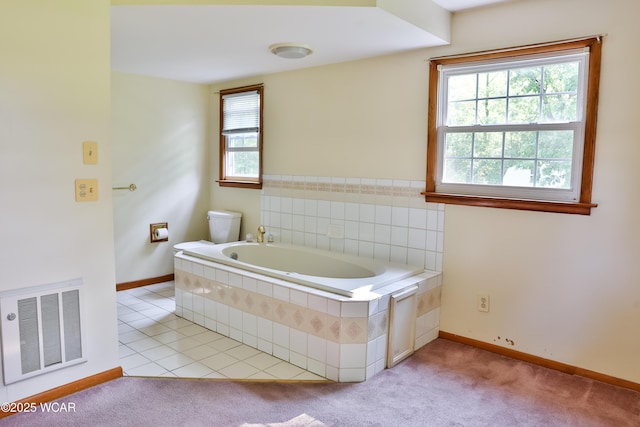 4940 Stewart Rd, Lima, OH 45801 - bathroom featuring a garden tub, baseboards, and toilet