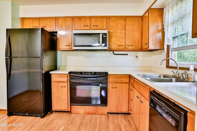 4940 Stewart Rd, Lima, OH 45801 - kitchen featuring black appliances, a sink, light wood finished floors, and light countertops