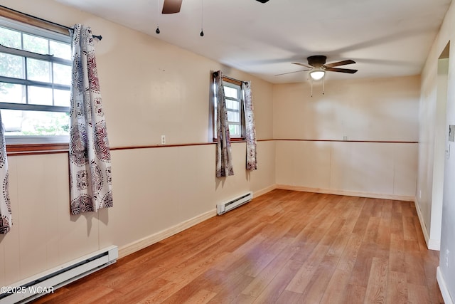 4940 Stewart Rd, Lima, OH 45801 - spare room featuring a ceiling fan, baseboard heating, light wood-type flooring, and baseboards