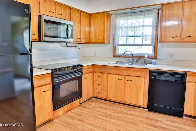 4940 Stewart Rd, Lima, OH 45801 - kitchen featuring black appliances, a sink, light countertops, and light wood finished floors