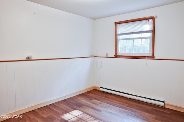 4940 Stewart Rd, Lima, OH 45801 - spare room featuring a baseboard heating unit and wood finished floors