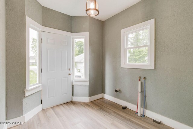 1157 W High St, Lima, OH 45805 - entryway featuring wood finished floors, baseboards, and a textured wall