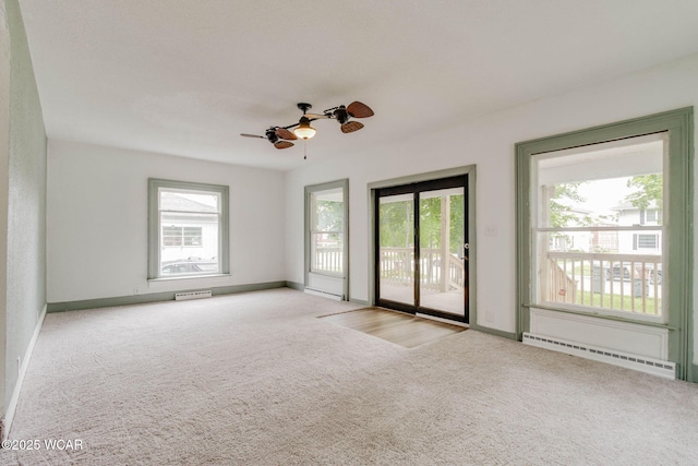 1157 W High St, Lima, OH 45805 - spare room with a baseboard heating unit, carpet, plenty of natural light, and baseboards