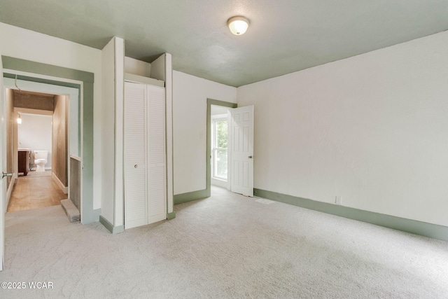 1157 W High St, Lima, OH 45805 - unfurnished bedroom with carpet flooring, a closet, and baseboards