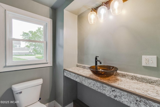 1157 W High St, Lima, OH 45805 - half bathroom featuring toilet, a chandelier, and vanity