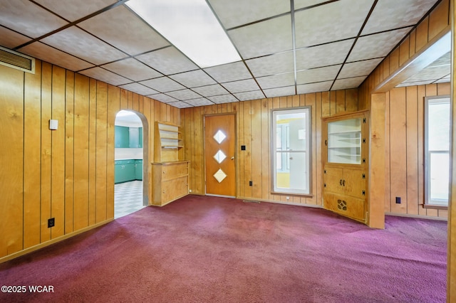 100 W S St, Columbus Grove, OH 45830 - unfurnished room with wooden walls, carpet, and arched walkways