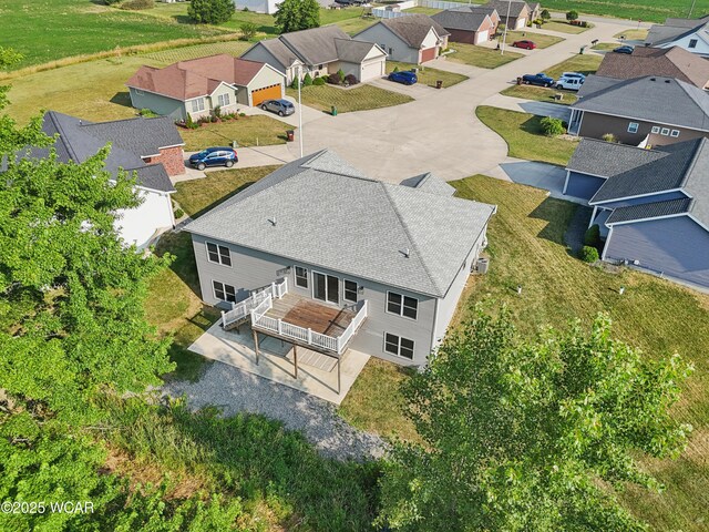 6856 Creekview Ct, Huntsville, OH 43324 - ranch-style house featuring a front yard, concrete driveway, a garage, and a shingled roof