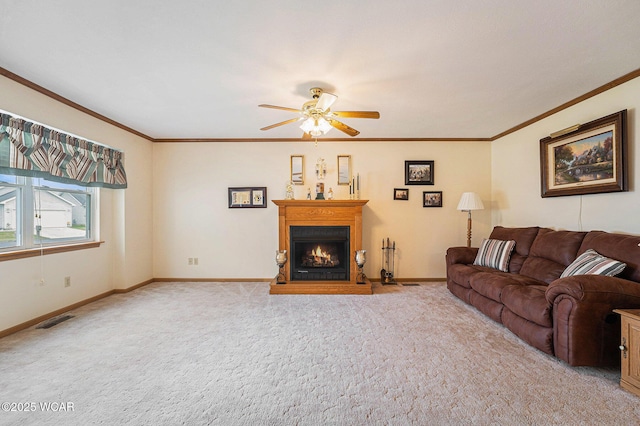 354 Stone Hedge Ln, Kenton, OH 43326 - carpeted living room with a ceiling fan, a lit fireplace, and crown molding