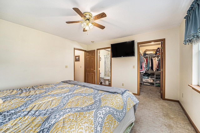 354 Stone Hedge Ln, Kenton, OH 43326 - bedroom featuring a spacious closet, light colored carpet, a closet, ensuite bath, and ceiling fan