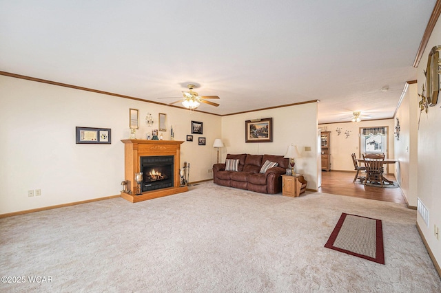 354 Stone Hedge Ln, Kenton, OH 43326 - carpeted living room featuring ceiling fan, ornamental molding, and a lit fireplace