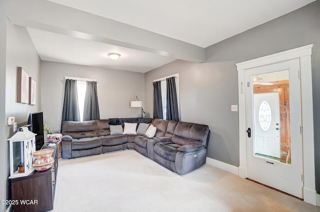 living room with beamed ceiling and carpet