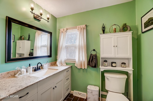 bathroom featuring hardwood / wood-style flooring, vanity, and toilet