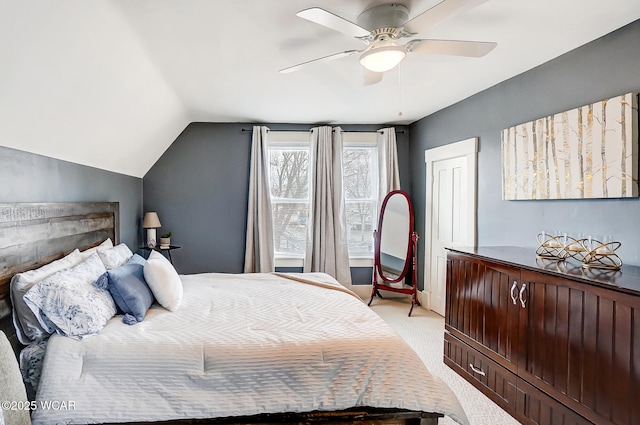 carpeted bedroom featuring ceiling fan, vaulted ceiling, and a closet