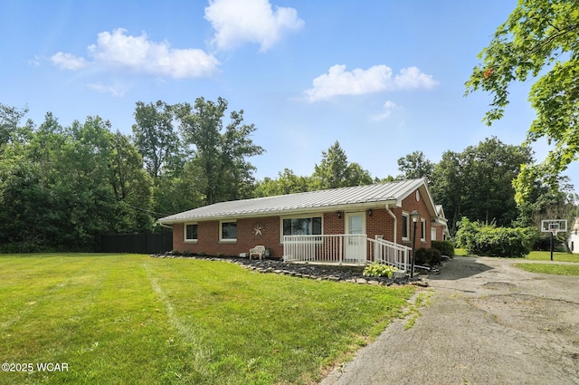 2170 E Hanthorn Rd, Lima, OH 45804 - ranch-style house with brick siding, a front yard, driveway, and a metal roof