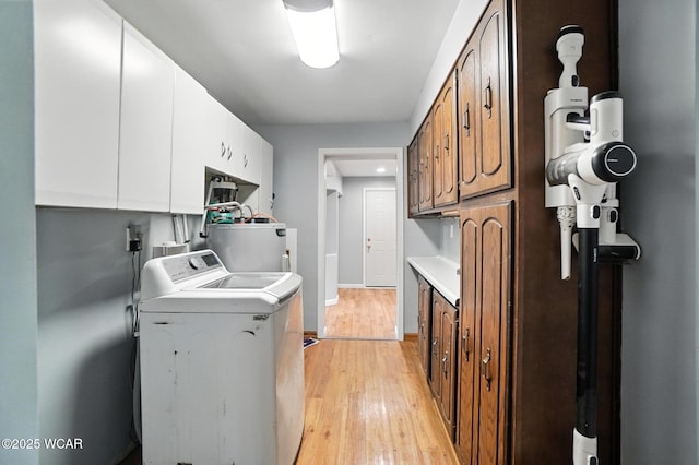 2170 E Hanthorn Rd, Lima, OH 45804 - laundry room featuring washer / clothes dryer, water heater, cabinet space, and light wood finished floors