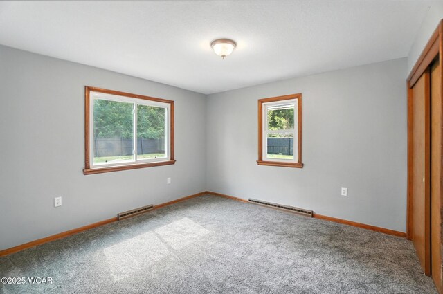 2170 E Hanthorn Rd, Lima, OH 45804 - unfurnished bedroom with carpet flooring, baseboard heating, and a closet