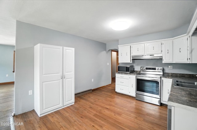 2170 E Hanthorn Rd, Lima, OH 45804 - kitchen with appliances with stainless steel finishes, under cabinet range hood, arched walkways, dark countertops, and white cabinets