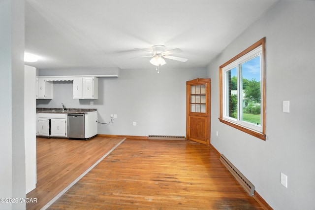 2170 E Hanthorn Rd, Lima, OH 45804 - kitchen with baseboard heating, stainless steel dishwasher, white cabinetry, light wood-style floors, and ceiling fan