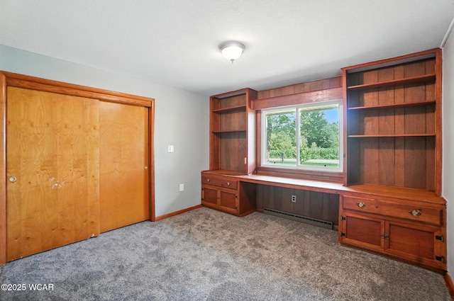 2170 E Hanthorn Rd, Lima, OH 45804 - unfurnished office featuring a baseboard heating unit, built in desk, and carpet flooring
