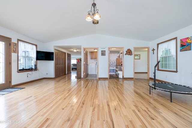 16949 Township Road 39, Belle Center, OH 43310 - unfurnished living room featuring vaulted ceiling, light wood-style flooring, a chandelier, and baseboards