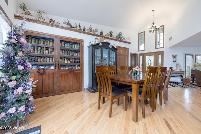 16949 Township Road 39, Belle Center, OH 43310 - dining area with a chandelier, hardwood / wood-style floors, plenty of natural light, and a high ceiling
