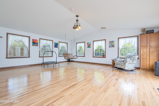 16949 Township Road 39, Belle Center, OH 43310 - exercise room featuring light wood-style floors, a chandelier, plenty of natural light, lofted ceiling, and baseboards