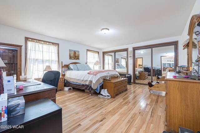 16949 Township Road 39, Belle Center, OH 43310 - bedroom featuring multiple closets, light wood finished floors, a desk, and french doors