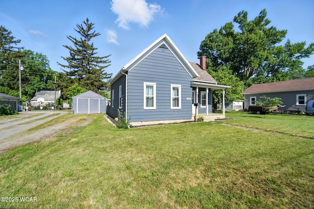 409 S Race St, Van Wert, OH 45891 - view of front of home featuring a chimney, dirt driveway, a front lawn, covered porch, and a detached garage