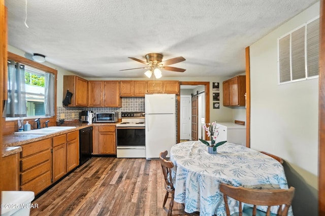 409 S Race St, Van Wert, OH 45891 - kitchen with white appliances, dark wood finished floors, a textured ceiling, brown cabinets, and tasteful backsplash