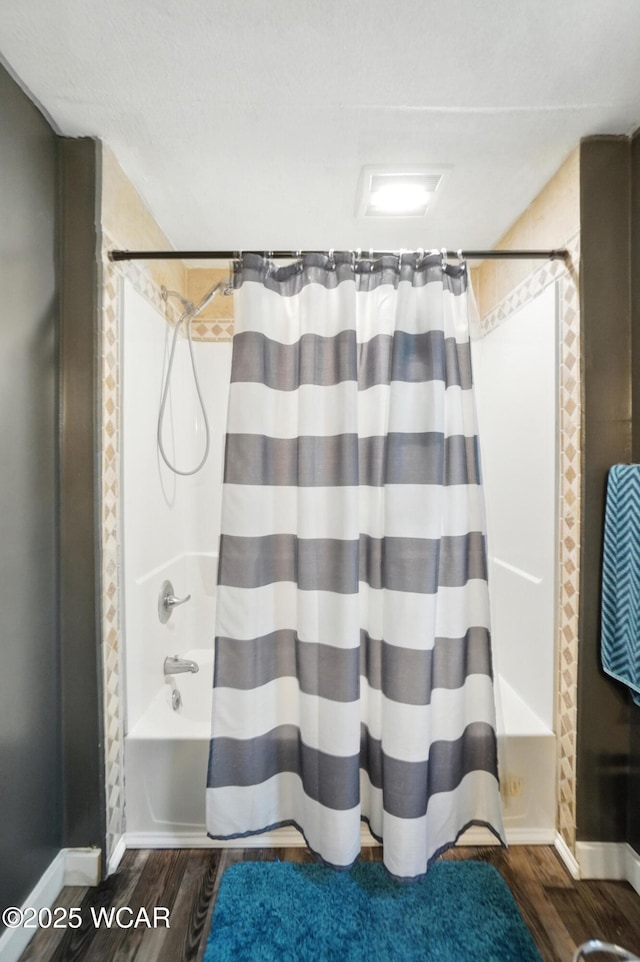 409 S Race St, Van Wert, OH 45891 - full bathroom featuring wood finished floors and shower / bath combo with shower curtain