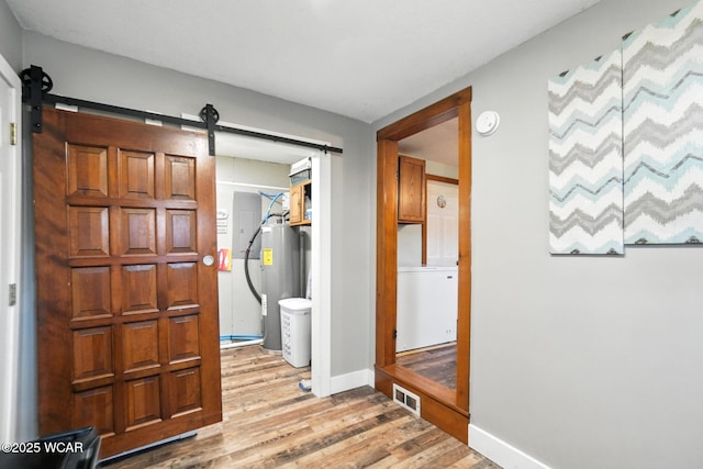 409 S Race St, Van Wert, OH 45891 - foyer entrance featuring electric water heater, a barn door, and light wood-type flooring