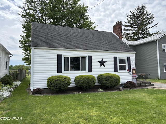 110 E Pearl St, Beaverdam, OH 45808 - view of front facade with a chimney, a shingled roof, and a front lawn