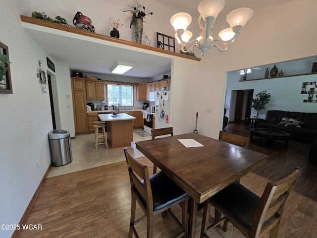 1919 Jared Pl, Lima, OH 45805 - dining room featuring a chandelier, light wood finished floors, and baseboards