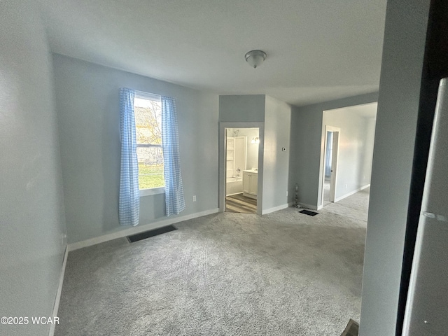 318 E E Vine St, Lima, OH 45804 - unfurnished bedroom featuring carpet flooring, baseboards, and ensuite bath