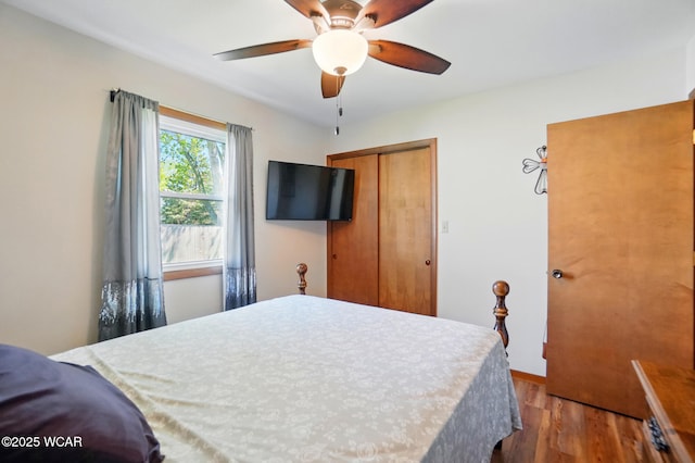 bedroom with baseboards, a closet, ceiling fan, and wood finished floors
