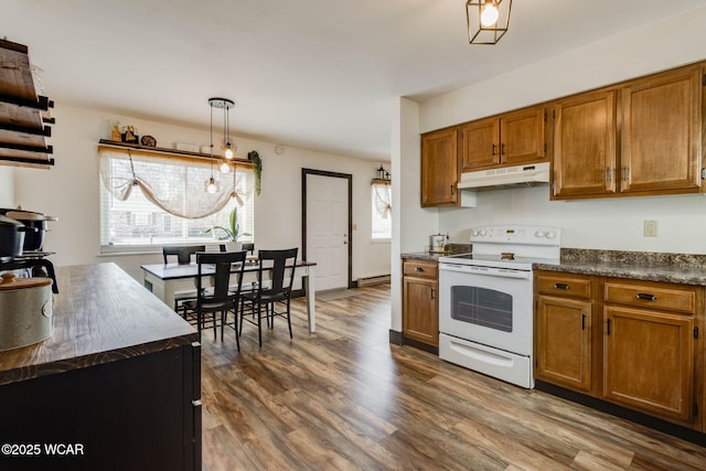 kitchen with dark wood-type flooring, pendant lighting, and white range with electric cooktop