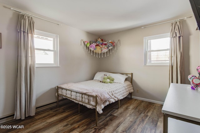 bedroom featuring multiple windows and dark hardwood / wood-style floors