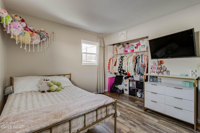 bedroom featuring hardwood / wood-style floors and a closet