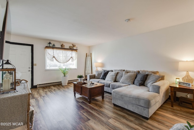 living room with a baseboard heating unit and hardwood / wood-style flooring