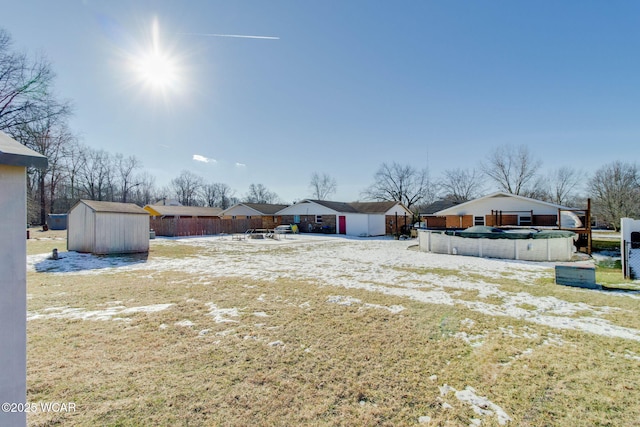 view of yard with a shed and a covered pool