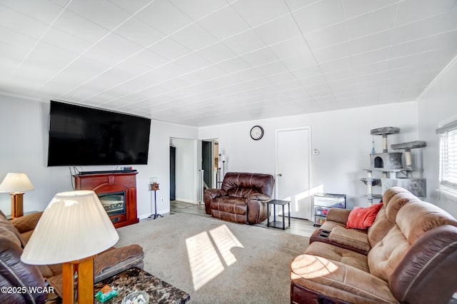 living room with ornamental molding and carpet flooring